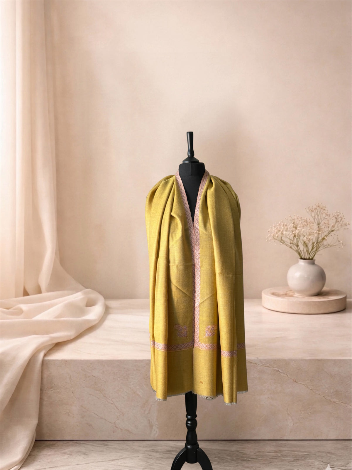 Two-sided mustard yellow pashmina shawl with lilac Sozni border worn over the shoulders, front view