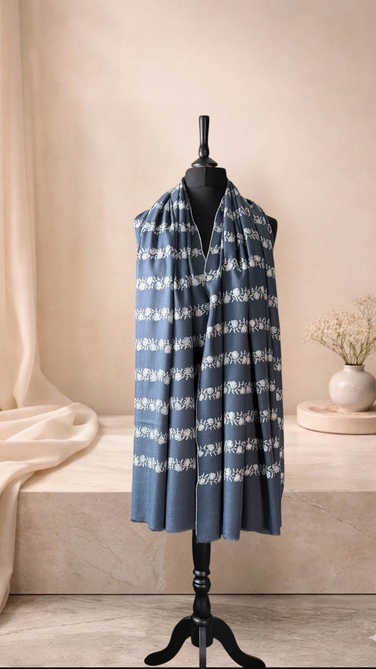 Slate blue pashmina shawl with ivory Sozni garlands worn over the shoulders, front view