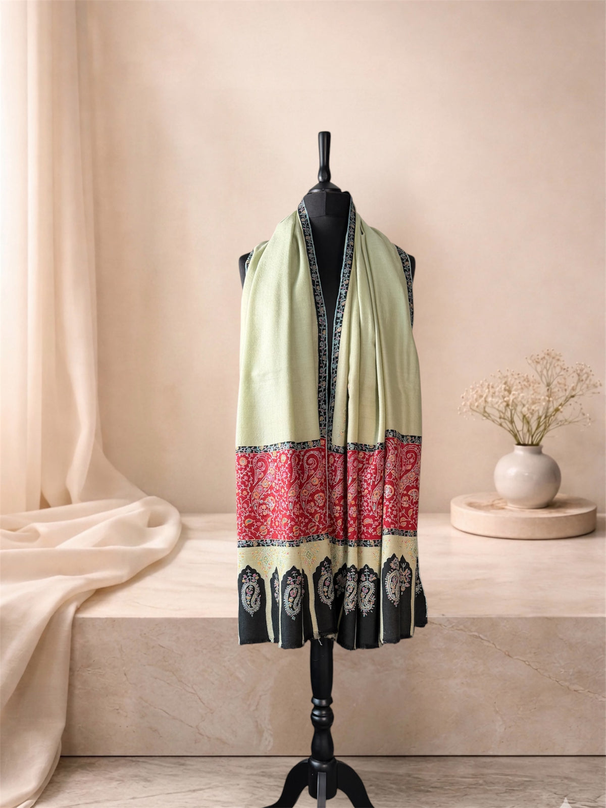 Kalamkari pistachio green pashmina shawl with red paisley band worn over the shoulders, front view