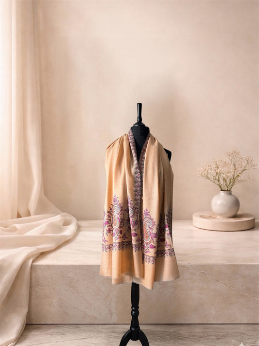 Cream pashmina shawl with plum and slate Sozni paisleys worn over the shoulders, front view