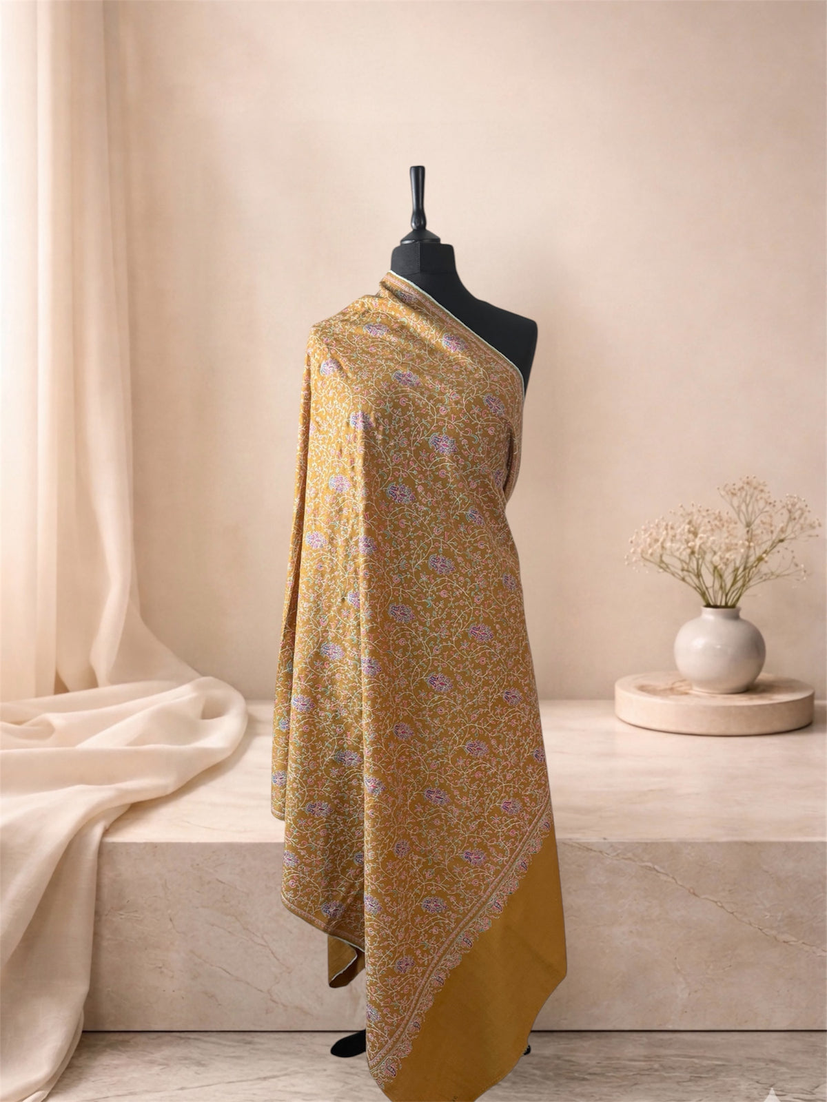 Mustard gold pashmina shawl with all-over Sozni floral jaal draped on a mannequin, side view