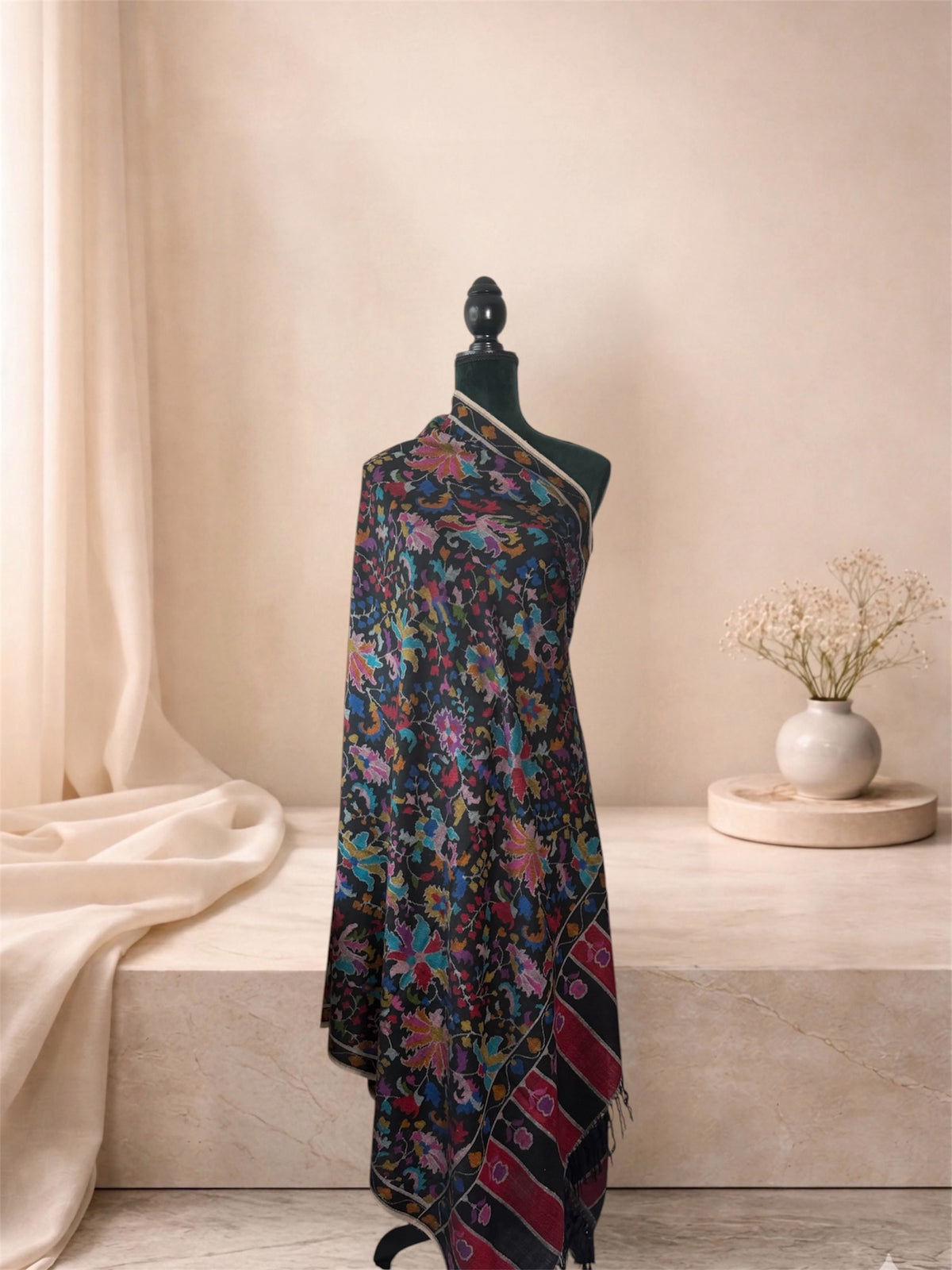 Black Kani pashmina shawl with multicolour floral jaal draped on a mannequin, side view