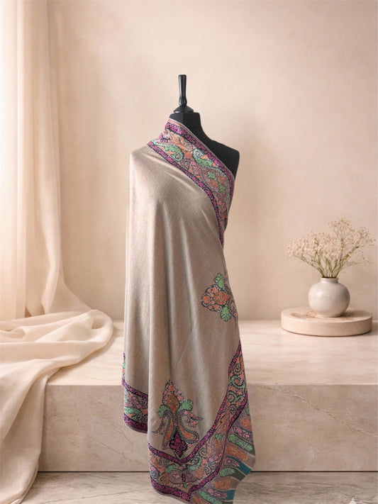 Kalamkari natural beige pashmina shawl with hand-painted multicolour paisley border draped on a mannequin, side view