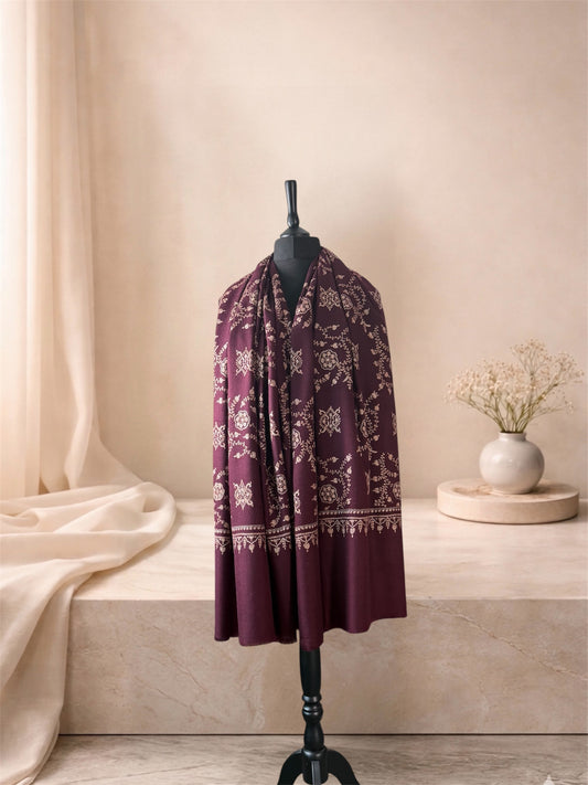 Plum pashmina shawl with ivory embroidery worn over the shoulders, front view