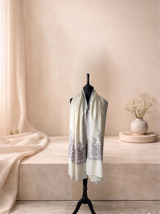 Ivory pashmina shawl with lilac floral embroidery worn over the shoulders, front view