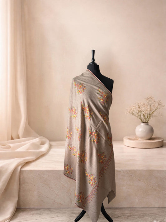 Natural beige pashmina shawl with multicolour floral butas draped on a mannequin, side view