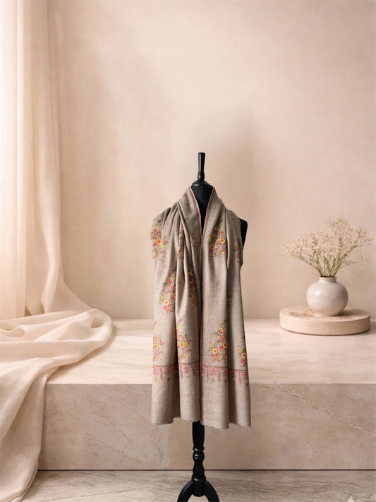 Natural beige pashmina shawl with Sozni floral embroidery worn over the shoulders, front view