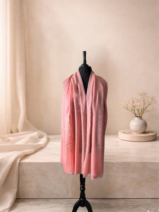 Coral pink pashmina shawl with Sozni vine embroidery worn over the shoulders, front view