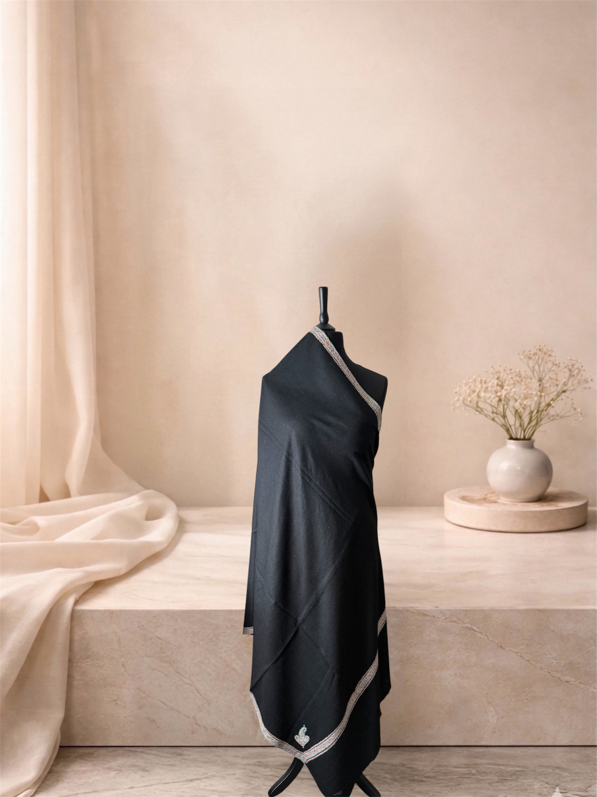 Black pashmina shawl with narrow ivory border draped on a mannequin, side view