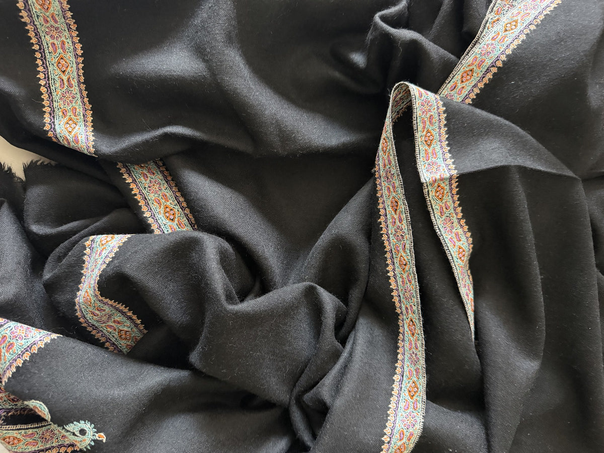 Close-up of ivory and gold Sozni border on black pashmina