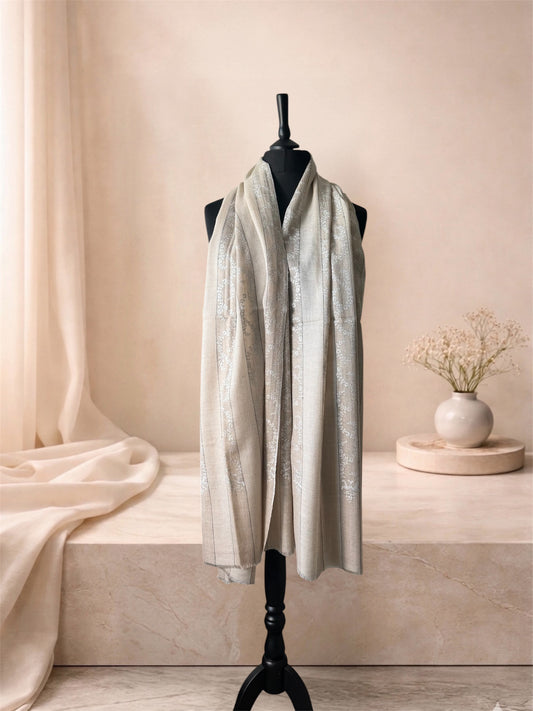 Natural striped pashmina shawl with ivory Sozni embroidery worn over the shoulders, front view