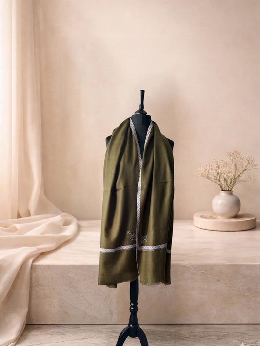 Olive green pashmina shawl with Sozni lattice border worn over the shoulders, front view