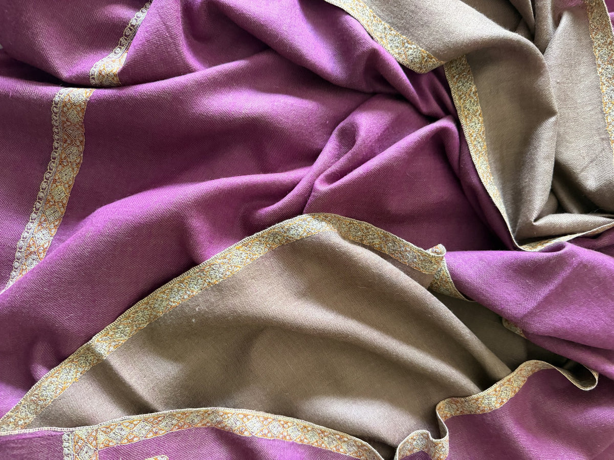 Close-up of gold Sozni border on orchid purple pashmina with taupe reverse