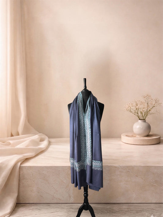 Lavender grey pashmina shawl with ivory Sozni border worn over the shoulders, front view