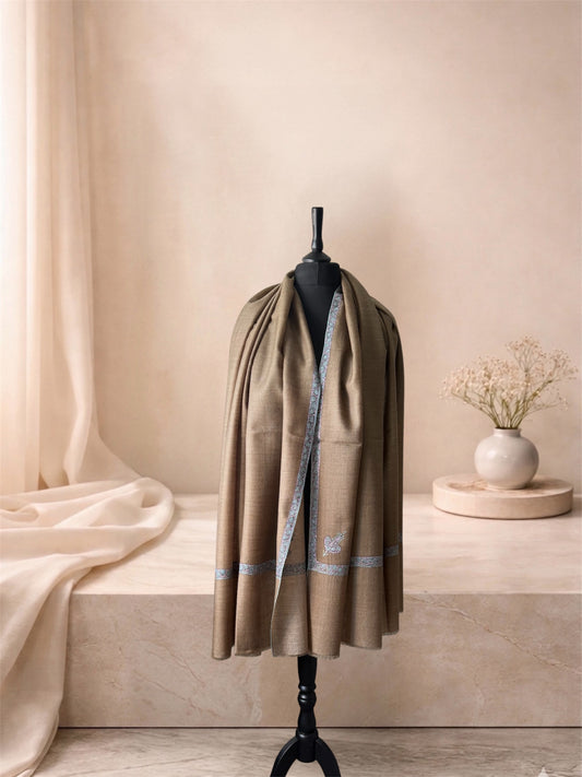 Taupe pashmina shawl with Sozni vine border worn over the shoulders, front view