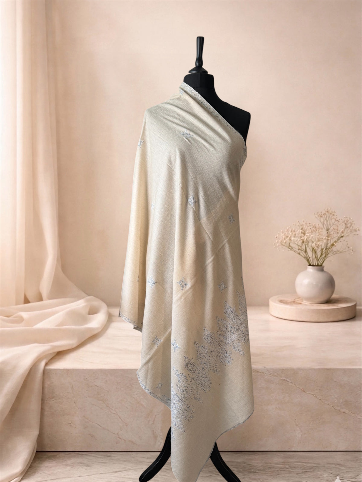 Cream pashmina shawl with powder blue paisley ends draped on a mannequin, side view
