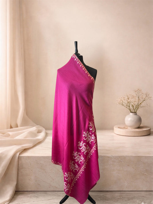 Fuchsia pink pashmina shawl with ivory floral scrolls draped on a mannequin, side view