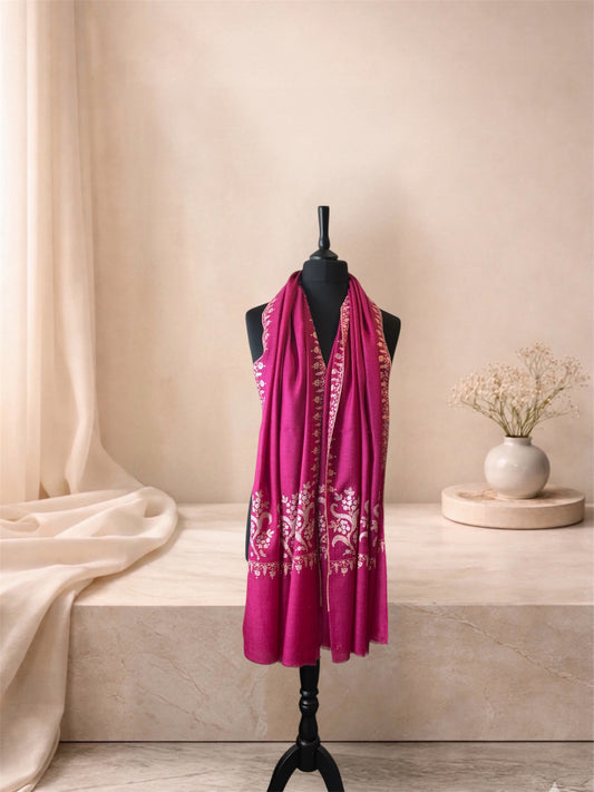 Fuchsia pink pashmina shawl with ivory Sozni embroidery worn over the shoulders, front view