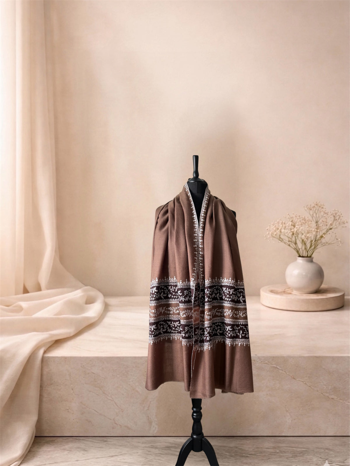 Camel pashmina shawl with ivory vine bands worn over the shoulders, front view