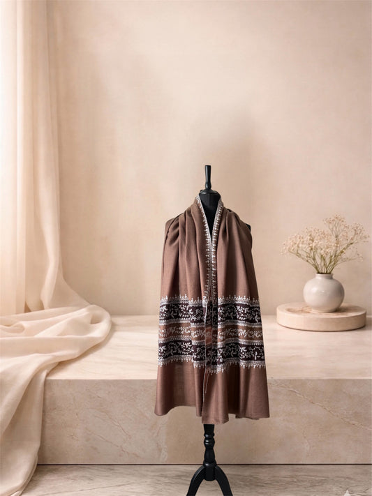 Camel pashmina shawl with ivory vine bands worn over the shoulders, front view