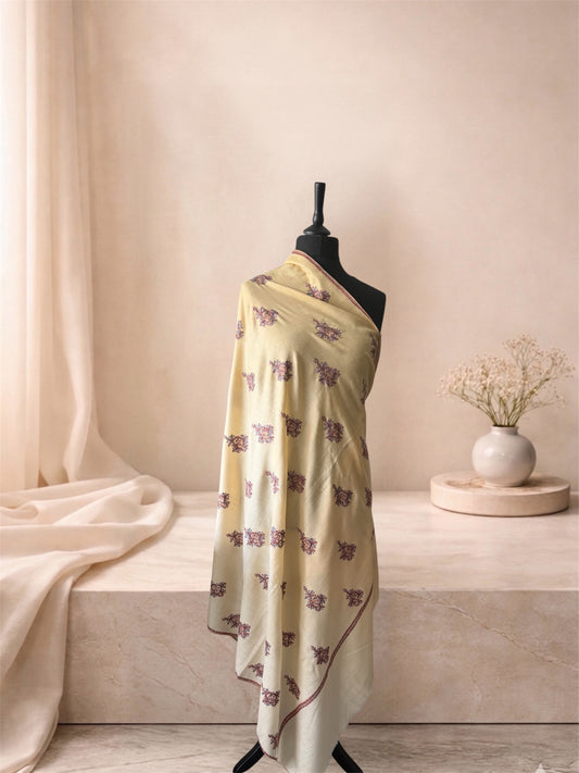 Buttercream pashmina shawl with plum floral butas draped on a mannequin, side view