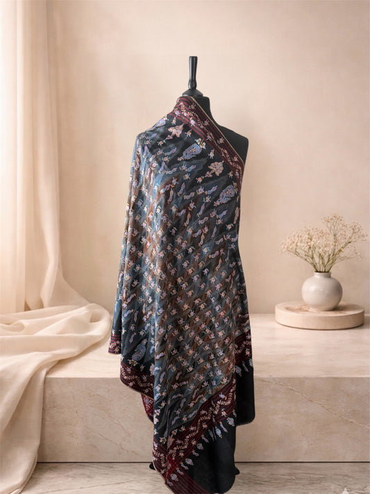 Black and slate ikat pashmina shawl with floral Sozni embroidery draped on a mannequin, side view