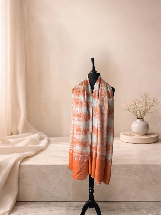 Orange and ivory ikat pashmina shawl worn over the shoulders, front view