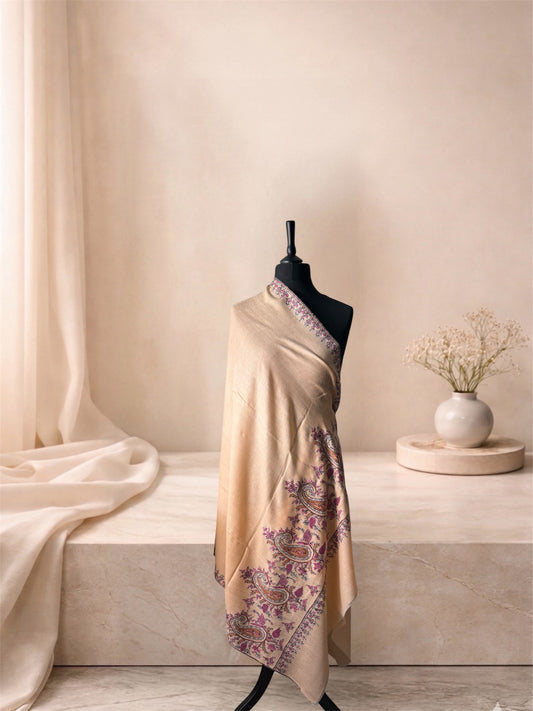 Cream pashmina shawl with plum paisley border draped on a mannequin, side view