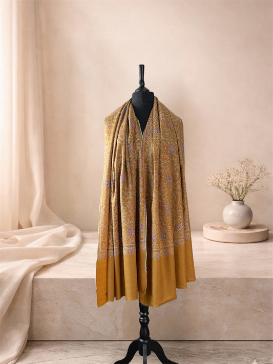 Mustard gold embroidered pashmina shawl worn over the shoulders, front view