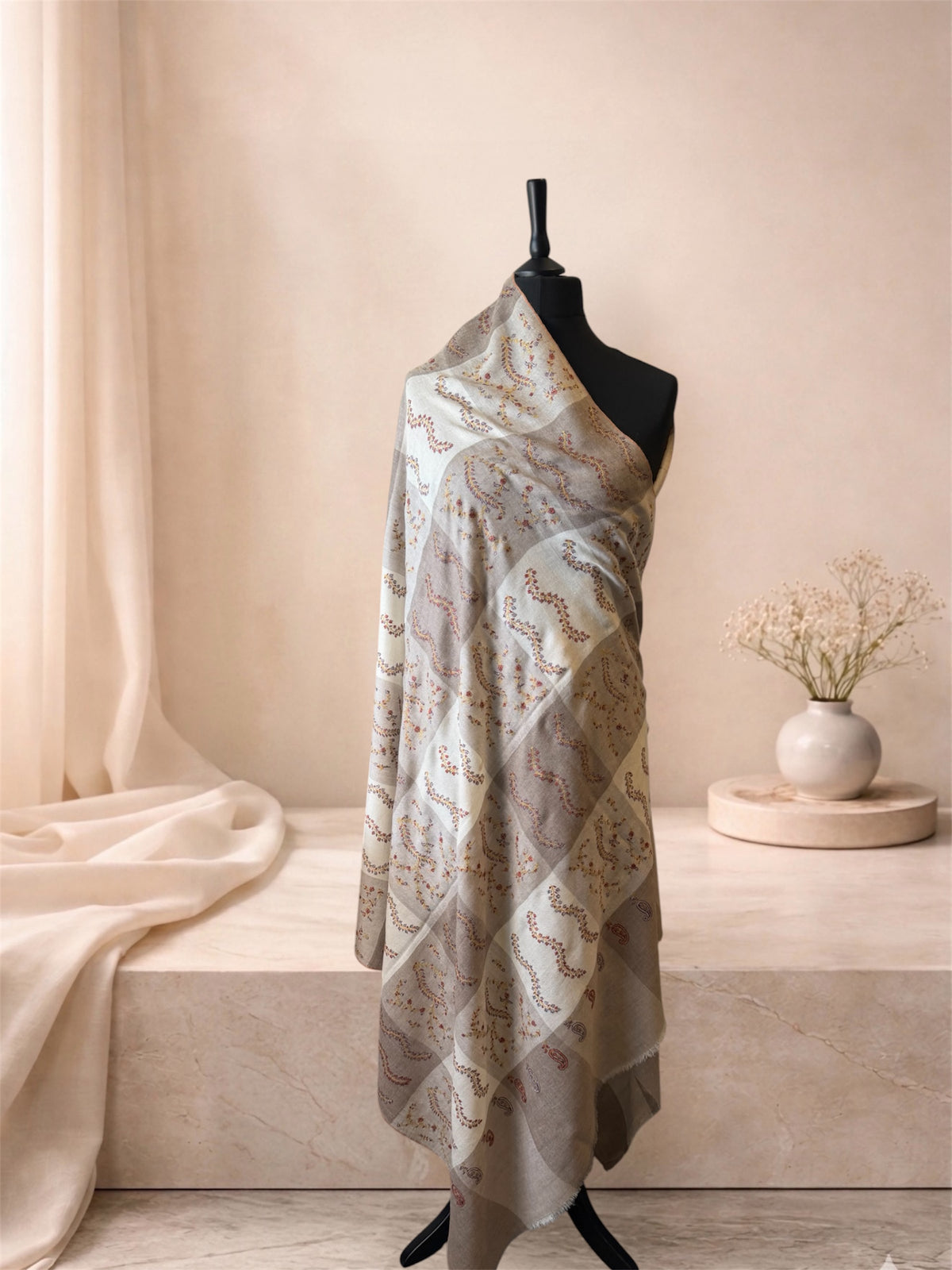 Taupe and ivory checked pashmina shawl with embroidered sprigs draped on a mannequin, side view