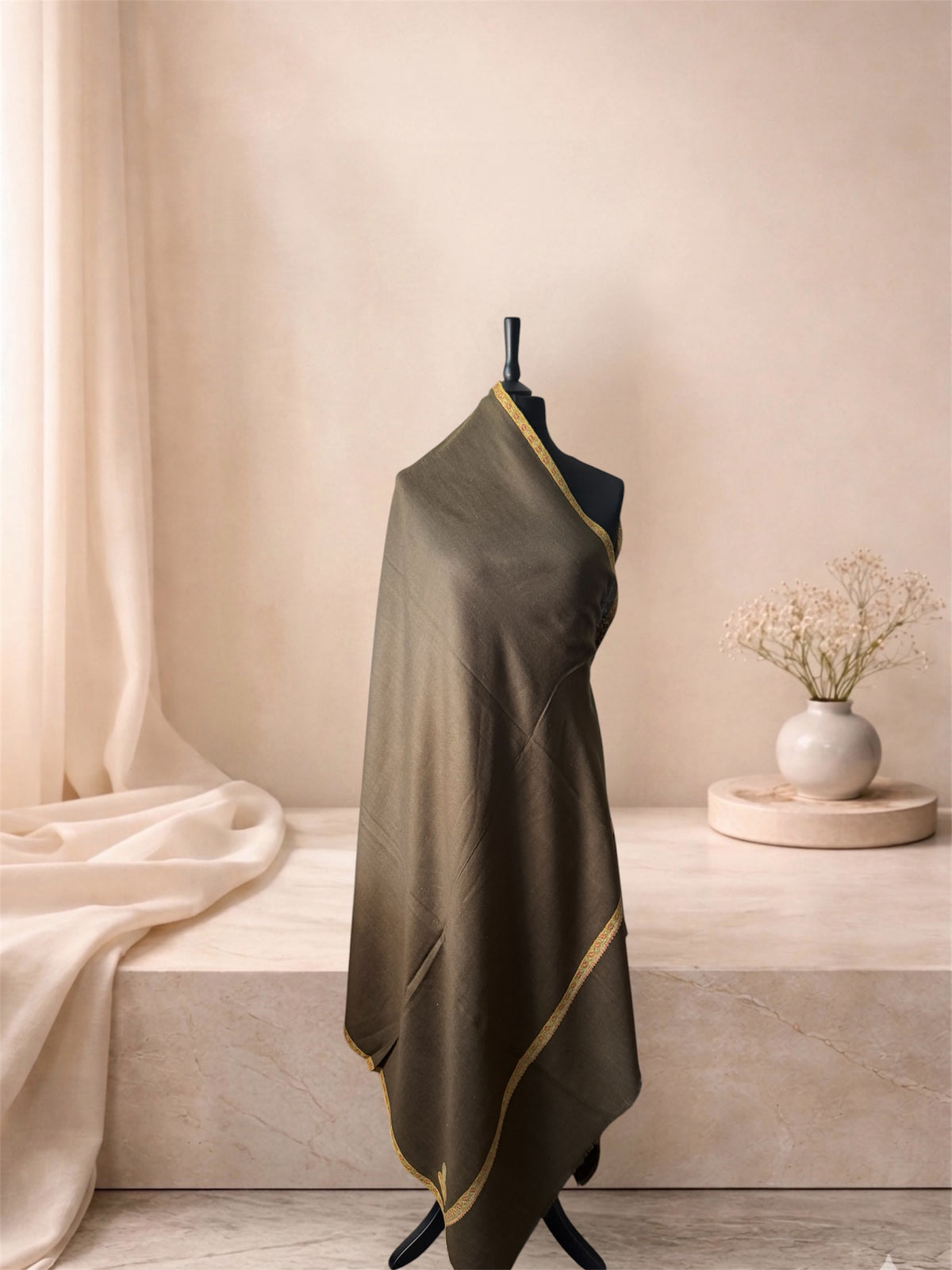 Mocha brown pashmina shawl with narrow gold border draped on a mannequin, side view
