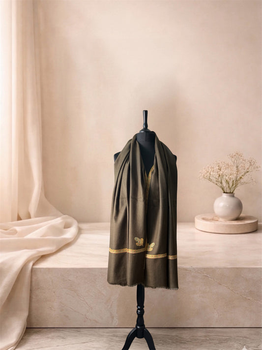 Mocha brown pashmina shawl with gold Sozni border worn over the shoulders, front view