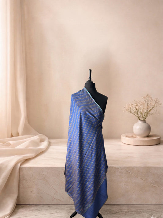 Two-sided striped pashmina shawl shown blue side out, draped on a mannequin, side view