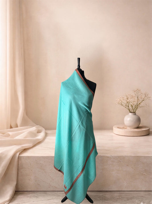 Aqua mint pashmina shawl with rust red border draped on a mannequin, side view