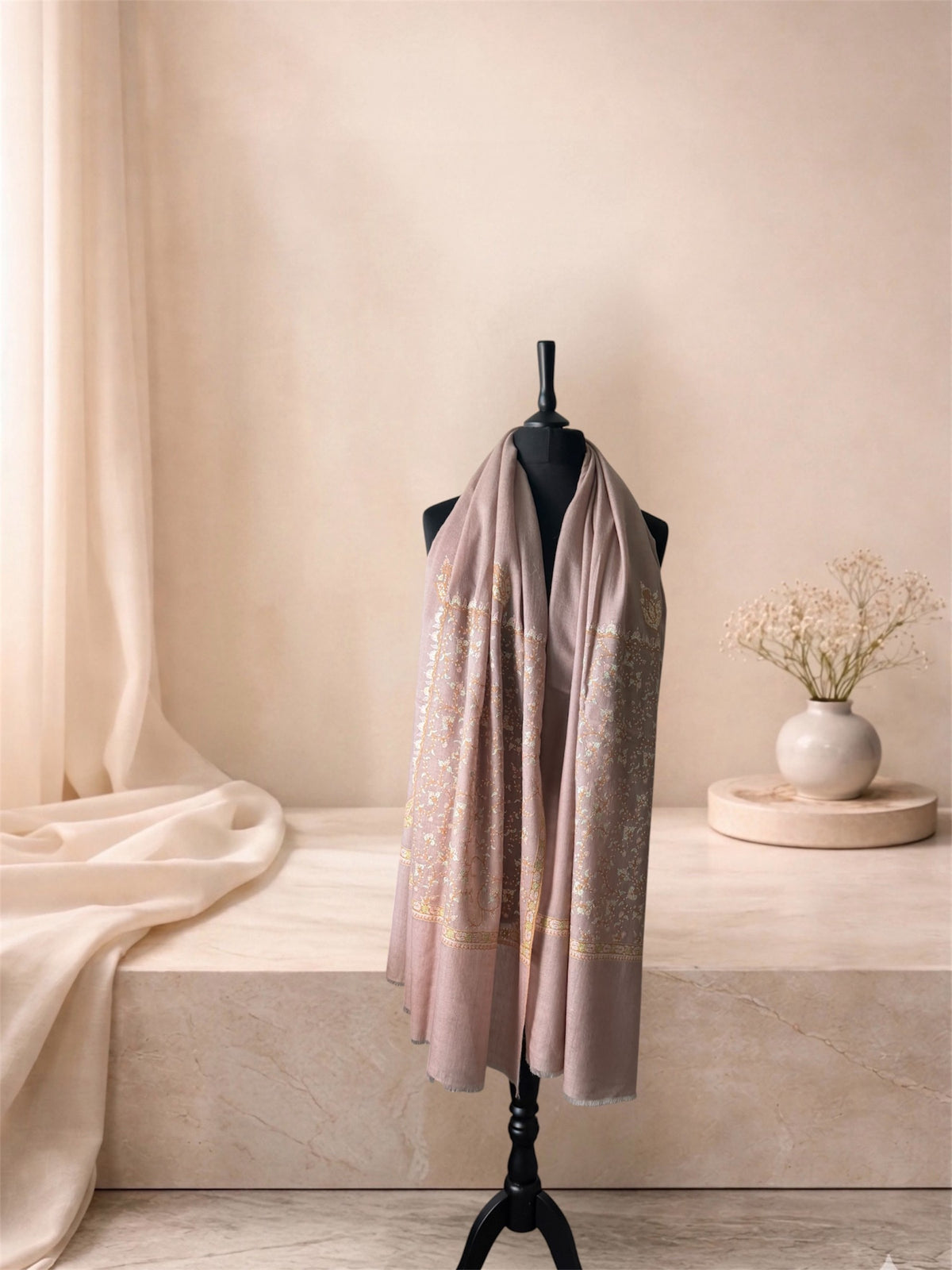 Rose taupe pashmina shawl with gold Sozni jaal ends worn over the shoulders, front view
