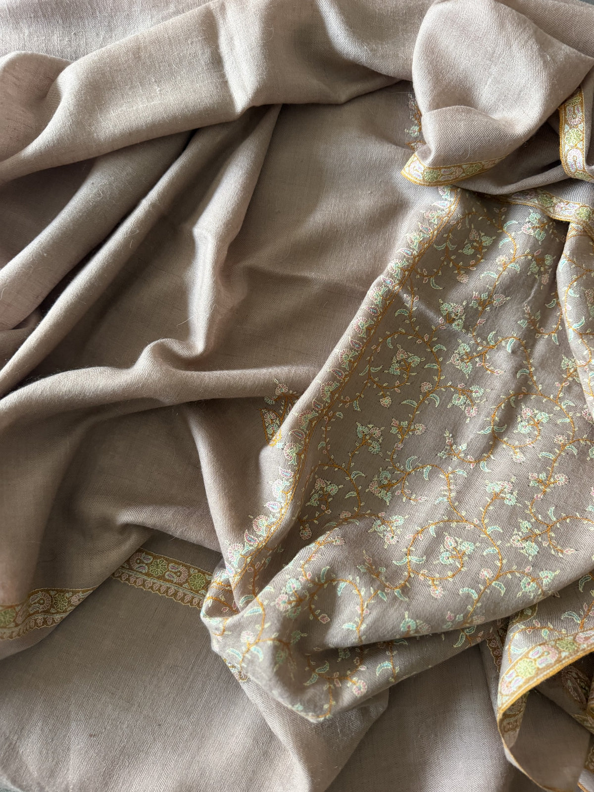 Close-up of gold, mint and blush Sozni floral vine jaal on taupe pashmina