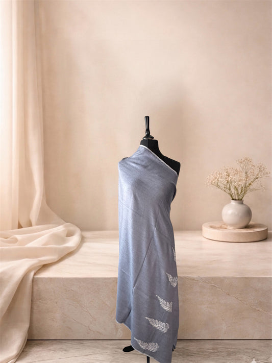Dove grey pashmina shawl with ivory leaf motifs draped on a mannequin, side view