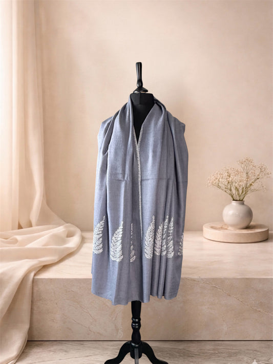 Dove grey pashmina shawl with ivory Sozni leaves worn over the shoulders, front view