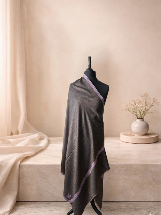 Charcoal brown pashmina shawl with rose pink border draped on a mannequin, side view