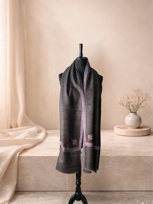 Charcoal brown pashmina shawl with pink Sozni border worn over the shoulders, front view