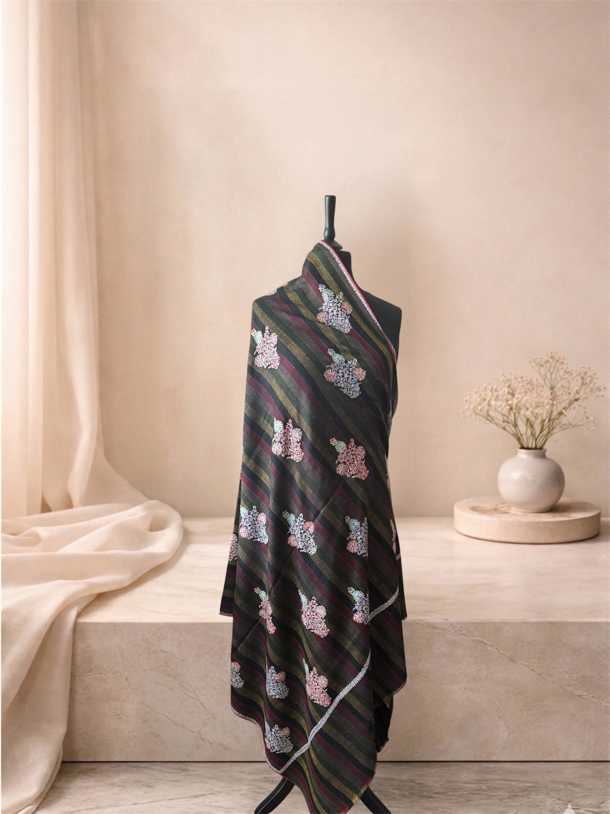 Charcoal and olive striped pashmina shawl with Sozni floral bouquets draped on a mannequin, side view