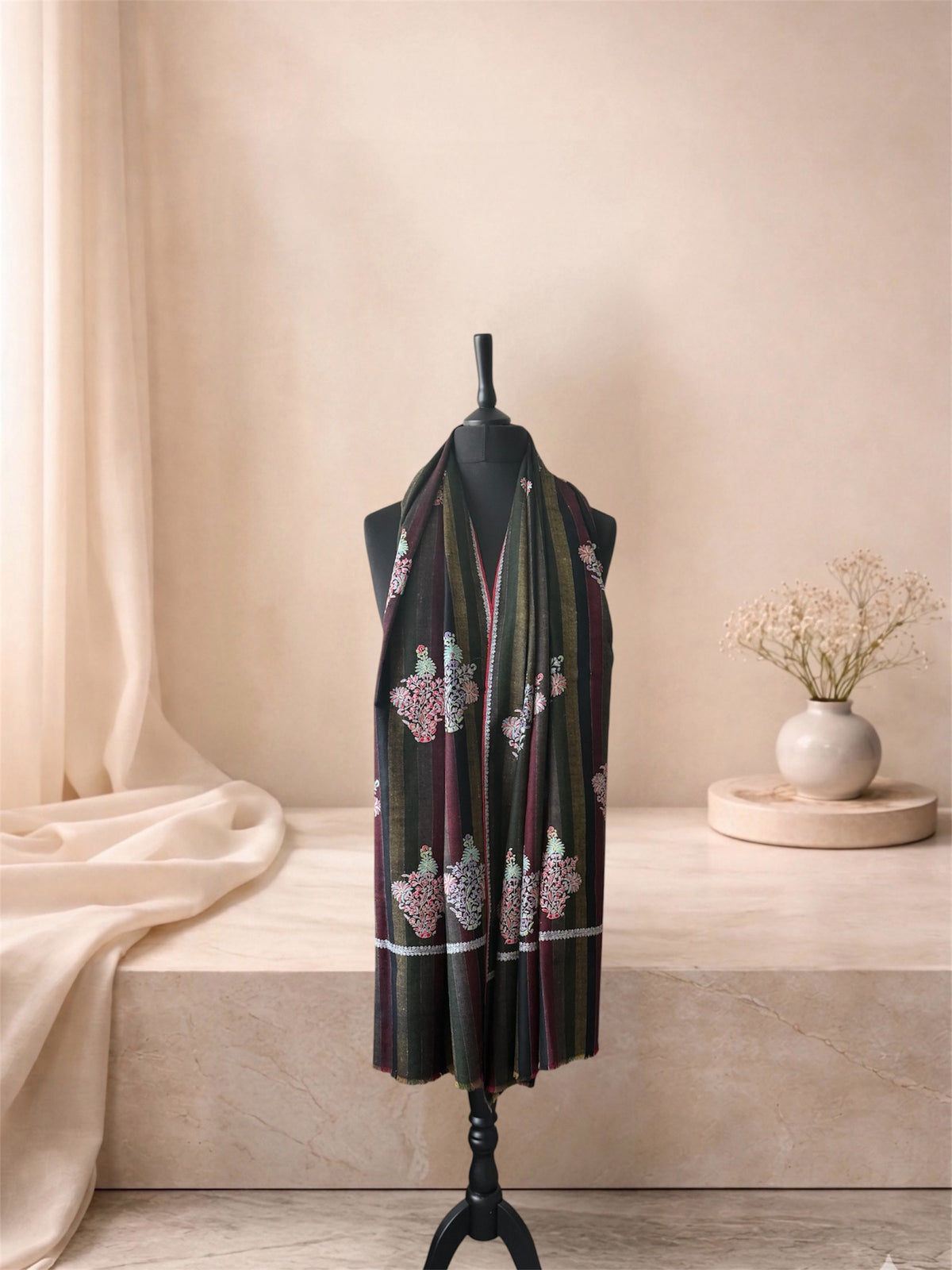 Dark striped pashmina shawl with embroidered floral buta worn over the shoulders, front view