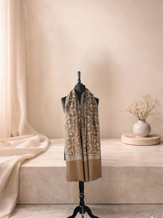 Olive brown pashmina shawl with ivory embroidery worn over the shoulders, front view