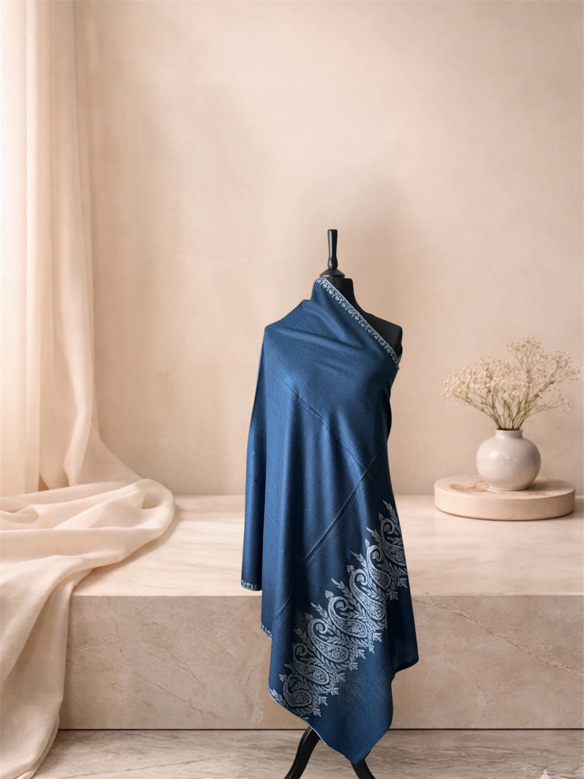 Indigo blue pashmina shawl with ivory Sozni paisley ends draped on a mannequin, side view