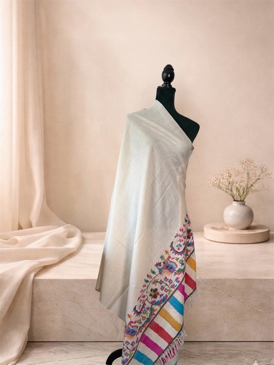Ivory Kani pashmina shawl with multicolour striped ends draped on a mannequin, side view