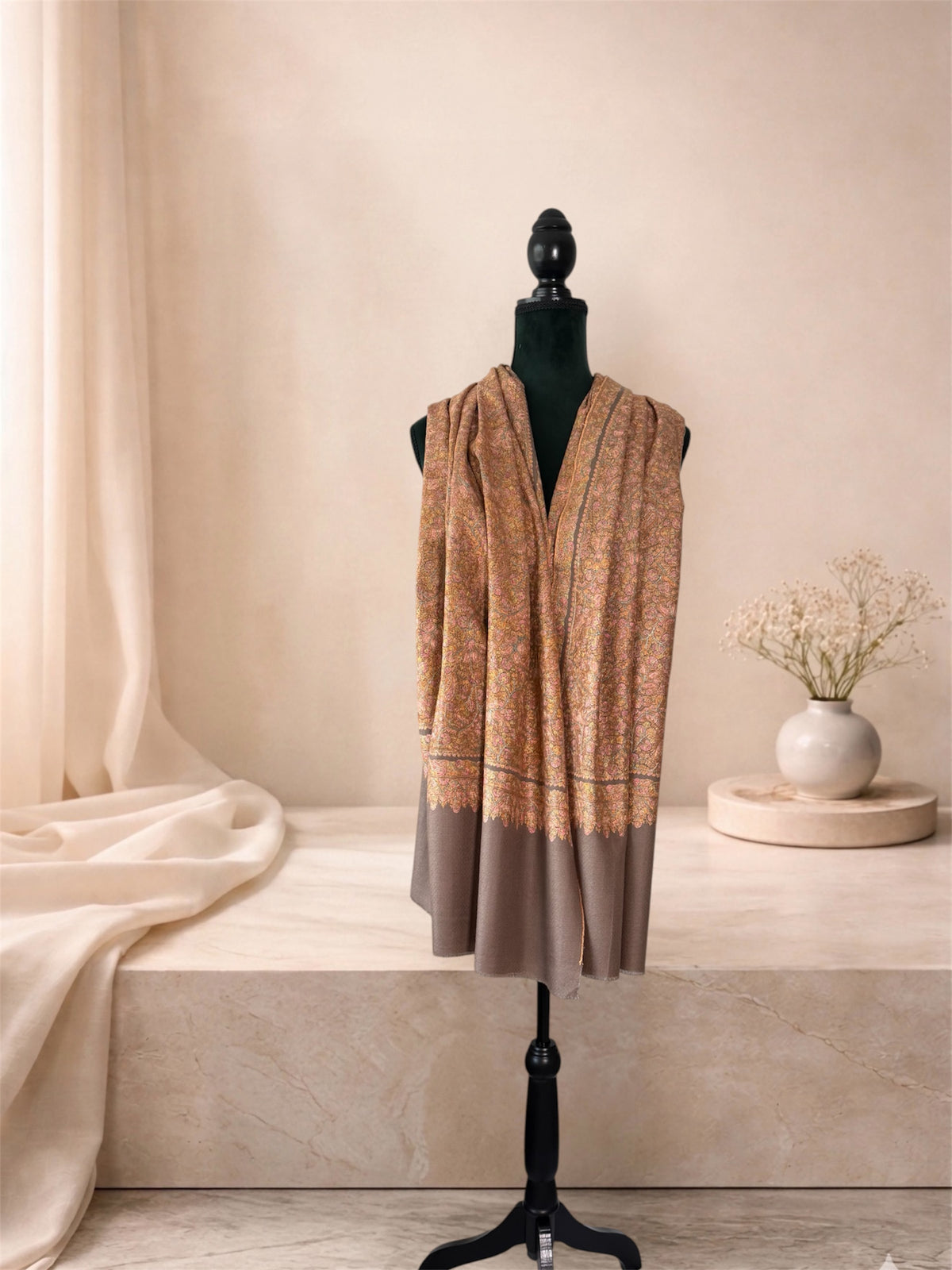 Grey pashmina shawl with gold Sozni embroidery and plain grey ends worn over the shoulders, front view