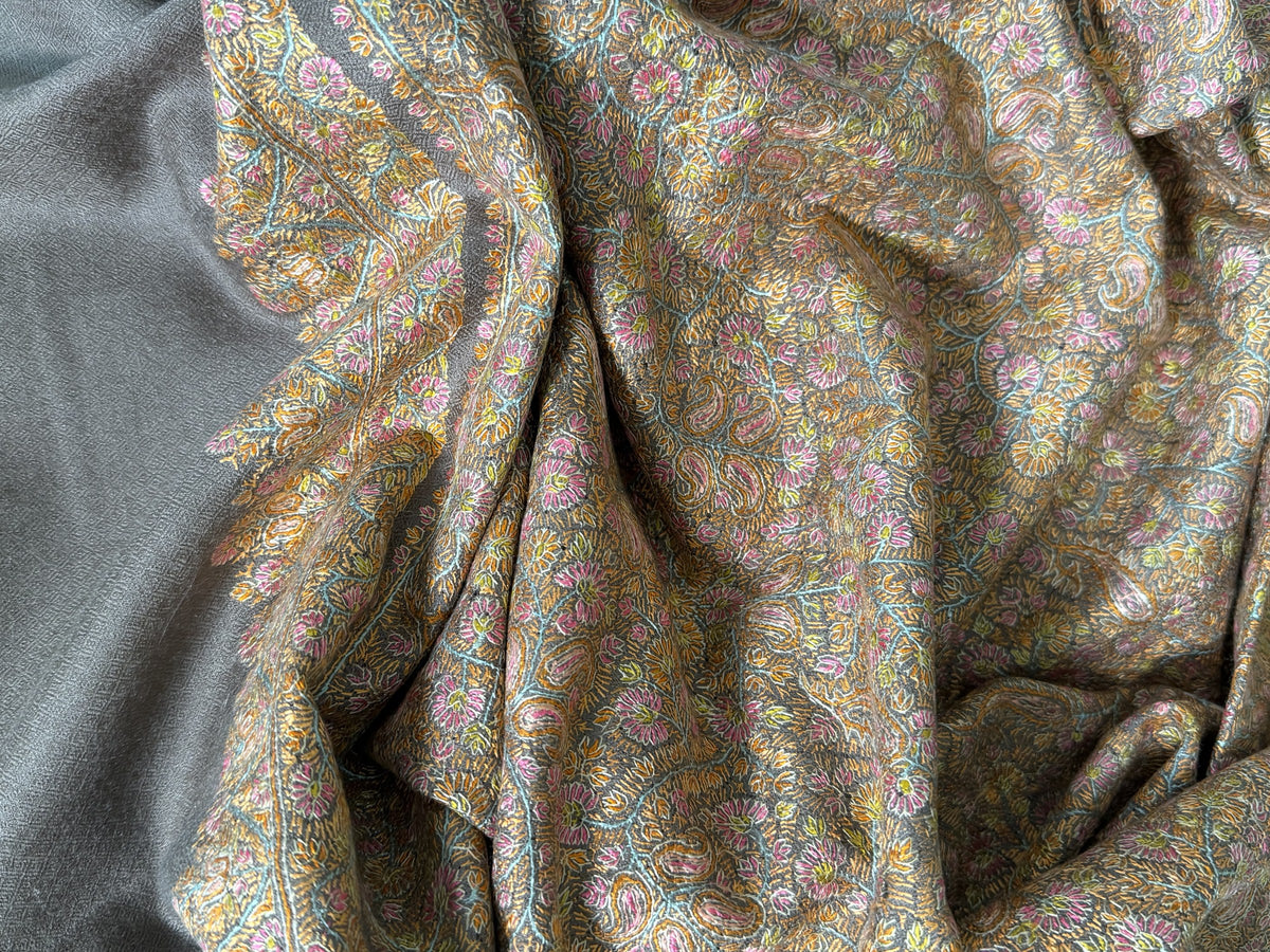 Close-up of gold, rose and aqua Sozni jaal on grey pashmina