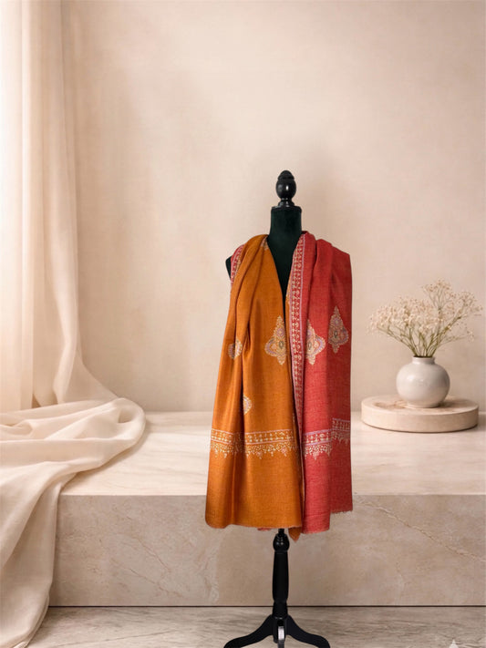 Mustard and brick red two-sided pashmina shawl worn over the shoulders, front view